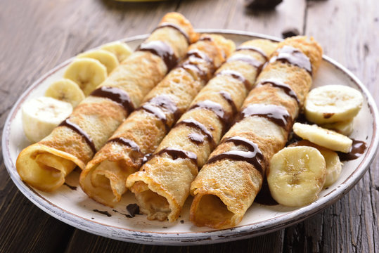 Delicious crepes roll with banana slices
