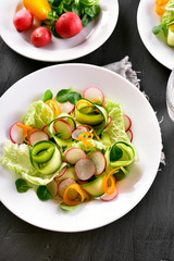 Vegetable salad from zucchini, radish, greens.