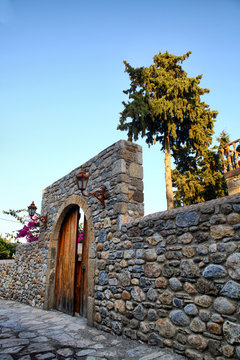 mediterranean style stone wall and wooden door