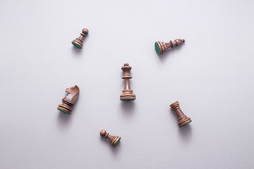 Obraz na płótnie Canvas Chess game figures on grey background , top view, flat lay