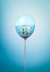 Silver fishes swimming in water minimal concept inside balloon. Flying balloon copy space idea with...