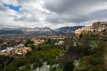 Fototapeta na wymiar View of the outskirts of Palermo and the surrounding snow dusted mountains from Monreale.