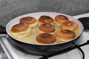 baking donuts in oil on a home stove