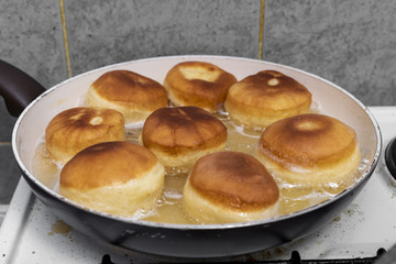 baking donuts in oil on a home stove