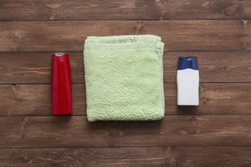 Obraz na płótnie Canvas Composition with plastic bottles and towel of body care and beauty products top view flat lay