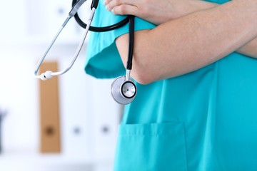 Unknown female doctor holds stethoscope closeup. Physician ready to examine and help patient....