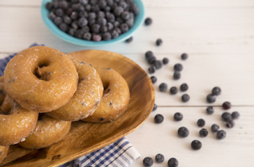 Blueberry Cake Donuts on a White Wooden Table