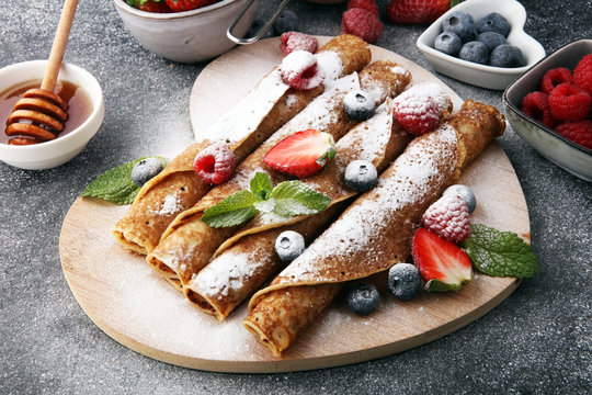 Delicious Tasty Homemade crepes or pancakes with raspberries and blueberries