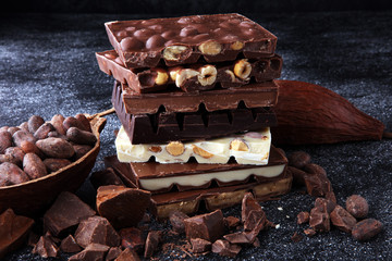 Chocolate bars on dark background with chocolate tower