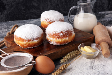 german donuts or berliner with ingredient on grey background