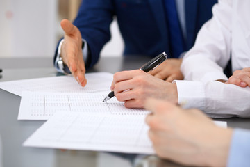 Bookkeepers team or financial inspectors  making report, calculating and checking balance. Tax service financial document. Audit or meeting concept