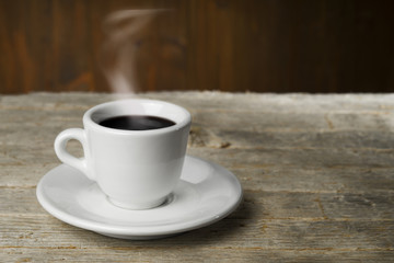 Cup of coffee on wooden table 