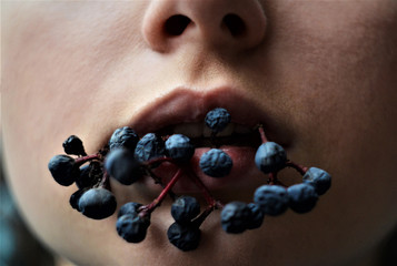 The half-open mouth of the girl who inhales the fragrance of cherry blossoms