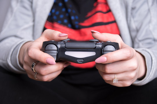 an image of a girl holding a black gaming pad