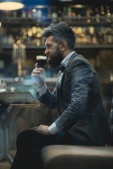 Businessman with long beard drink in cigar club. businessman with happy face drink beer at meeting.