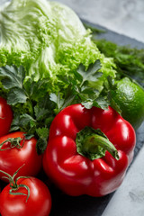 Healthy breakfast with tomatoes, letucce, lime on wooden background, close-up, selective focus, top view.