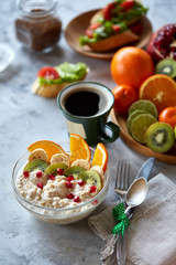 Breakfast still life with oatmeal porridge and fruits, top view, selective focus, shallow depth of field.