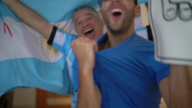 Argentina Father and Son Fans Watching and Celebrating a Soccer Game