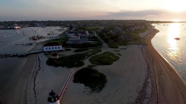 Aerial view of island and lighthouse at sunset