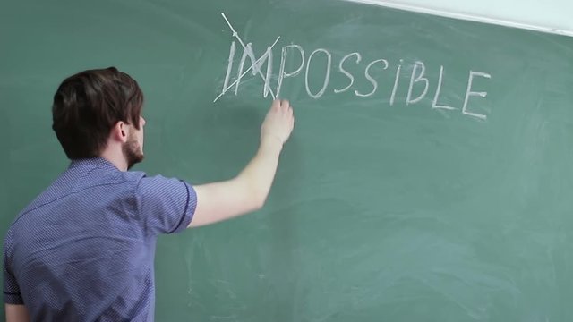 Guy correcting the inscription is impossible in possible. the concept of motivation and self-belief