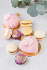 Close-up colorful French or Italian macaron on white wooden table. Macarons is French dessert served with tea or coffee. wallpaper, Vertical photo