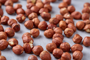 Raw hazelnut on heap isolated on white background, selective focus, shallow depth of field