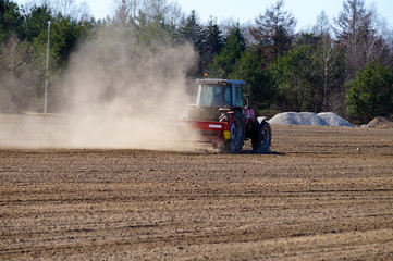Fototapeta premium Spring field work. The act of harrowing the field for cultivation