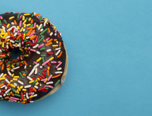 Chocolate Sprinkle Donuts on a Blue Background