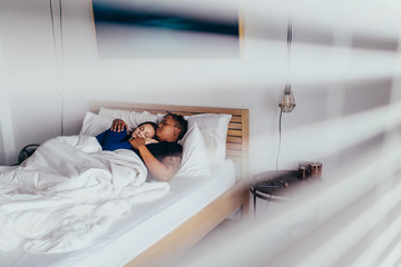 Interracial couple sleeping peacefully in bedroom