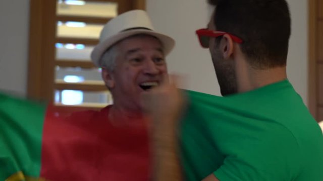 Portuguese Father and Son Fans Watching and Celebrating a Soccer Game