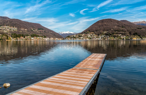 Landscape of lake Lugano and Swiss Alps from Lavena Ponte Tresa, province of Varese, Italy