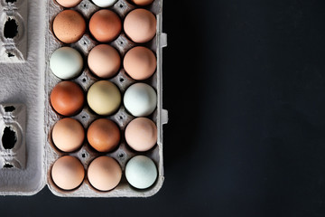 View from above of organic farm eggs isolated on black background for healthy food graphic.