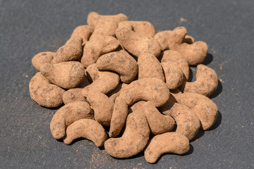 Cashew nuts covered with cocoa powder . Balinese dessert, Indonesia, island Bali