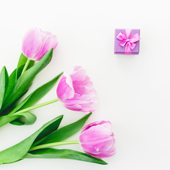 Tulip flowers and box. Pink tulips and gift box on white background. Flat lay, Top view.