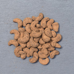 Cashew nuts covered with cocoa powder, close up . Balinese dessert, Indonesia, island Bali