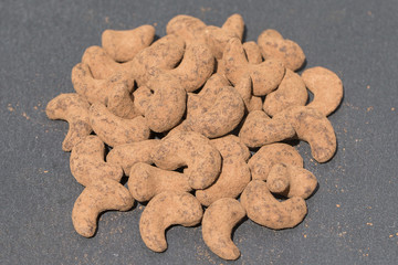 Cashew nuts covered with cocoa powder . Balinese dessert, Indonesia, island Bali