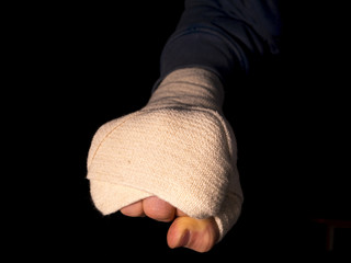 close up hand fist isolated taped on black background