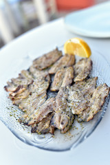 Grill cooked fish with lemon slices, Milos Island, Greece