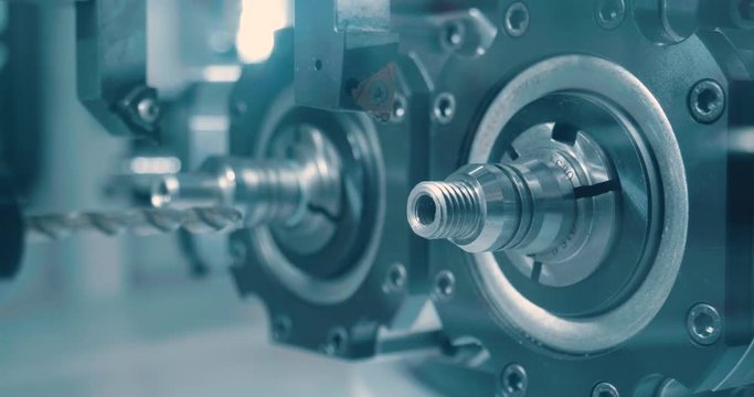 Close up of industrial automation and robotic engineering, in which the robot or mechanical arm build industrial parts. Concept of: robotics, engineering, technology and industry.