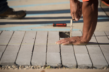 Close up view of man laying concrete brick