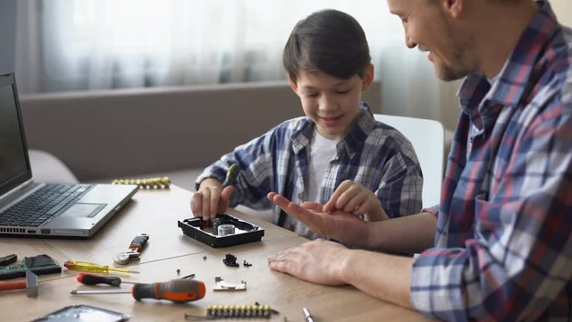 Father and son repairing small household appliances, support and reliance