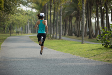 sporty fitness woman running at park