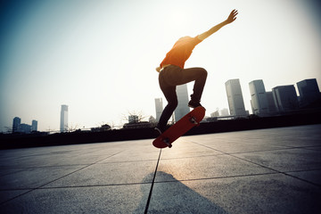 Skateboarder skateboarding at sunrise city