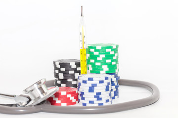 Thermometer and pile of casino chips on white background