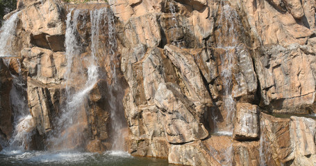 Waterfall over the rock wall