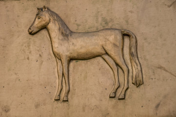 There is a bas-relief of a horse. Monument