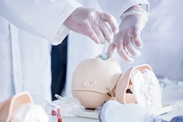 Doctors practising infant intubation