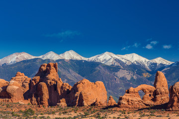 Summer scenery in Arches National Park, Utah, with red rock formations and clear blue sky