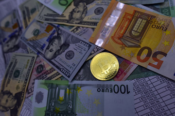 coin bitcoin lies on banknotes and sheets with numbers