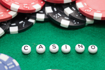 word "casino" with poker chips and money, gambling concept
